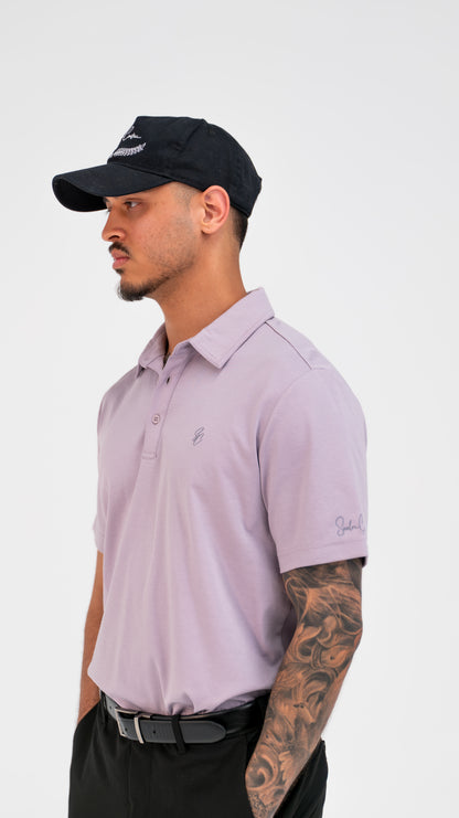 Model wearing Le Classique Polo in lilac with a Saalor Couture cap, three-quarter view