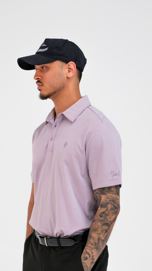 Model wearing Le Classique Polo in lilac with a Saalor Couture cap, three-quarter view