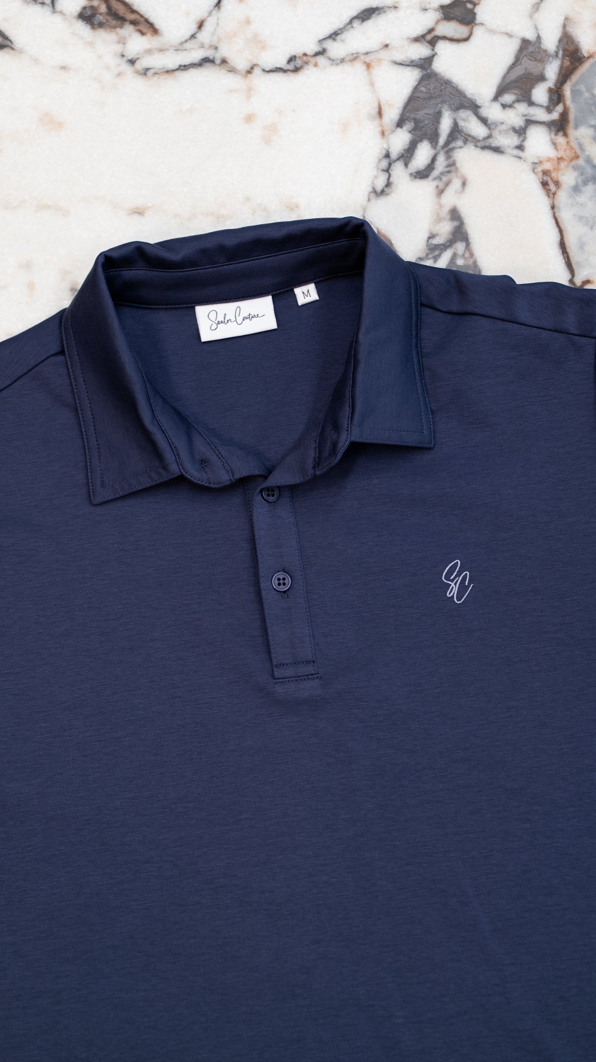 Le Classique Polo in navy, flat lay showing collar and placket detail