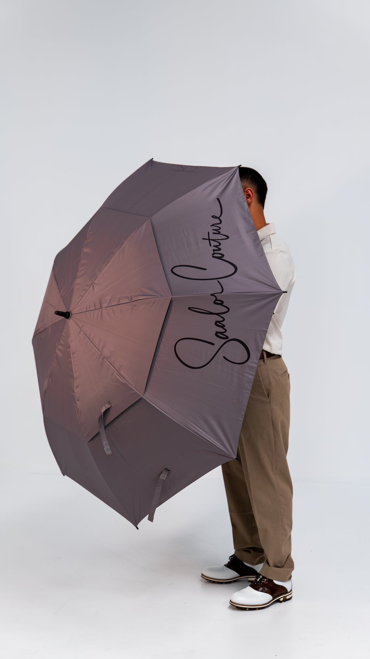 The Parapluie golf umbrella open, showing the Saalor Couture script on the canopy